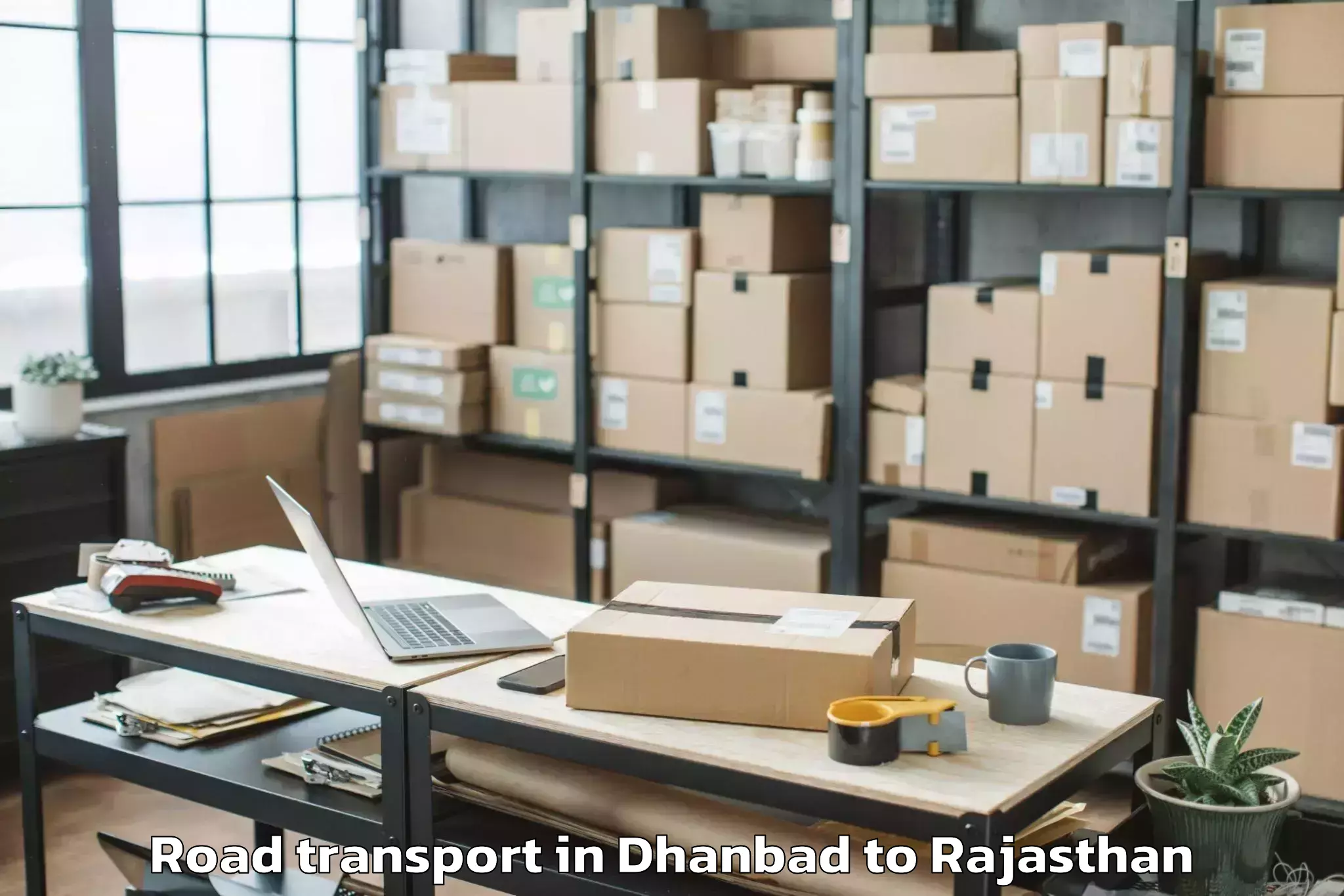 Reliable Dhanbad to Opjs University Churu Road Transport